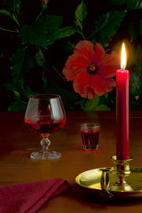 Red wine, liquor and a burning candle