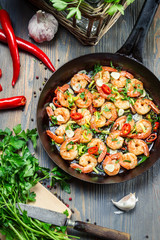 Fresh vegetables and shrimps on old pan