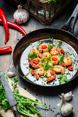Shrimps served on a pan with fresh herbs
