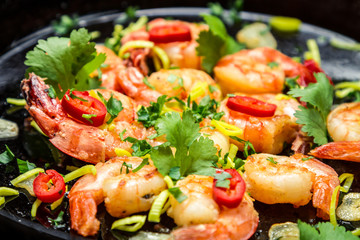 Fresh shrimps on old pan with garlic