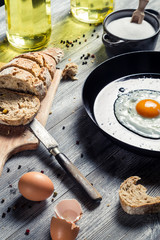Egg served with bread on a pan in countryside