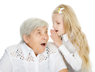 girl telling an astonished old woman some secrets. isolated