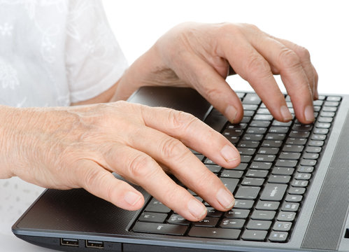 Old person hands typing on a keyboard. isolated