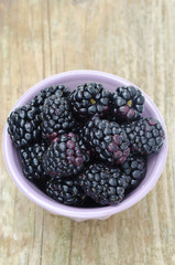bowl of fresh blackberries close-up top view