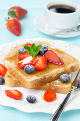 crispy toast with honey, fresh strawberries and blueberries