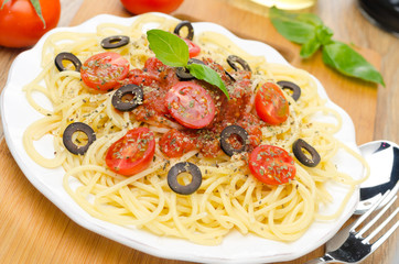 spaghetti with tomato sauce, cherry tomatoes and olives