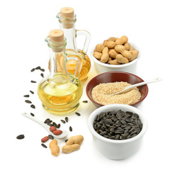 Sunflower seeds, peanuts and oil isolated on white