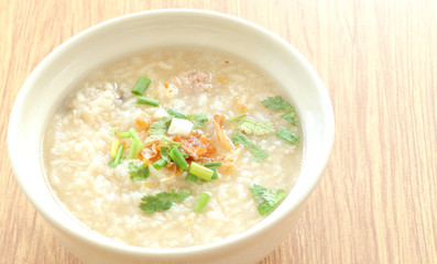 Congee round bowl on wood texture tile floor.