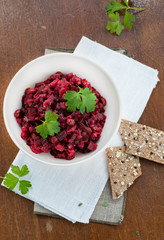 Salad with beetroot, potatoes, pickled cucumber and green peas