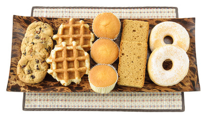 Cakes, cookies, donuts and waffels on the plate