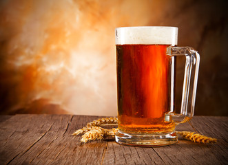 Glass of beer on wooden table