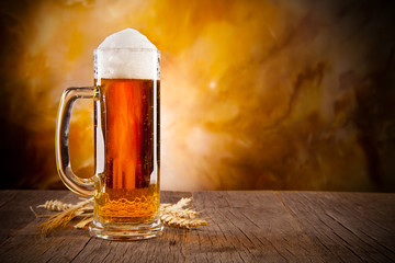 Glass of beer on wooden table