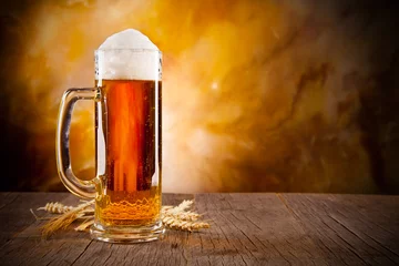 Fototapeten Glass of beer on wooden table © Jag_cz