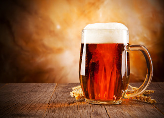 Glass of beer on wooden table