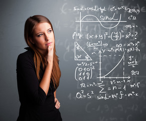 Beautiful school girl thinking about complex mathematical signs