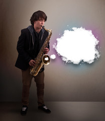 Young man playing on saxophone with copy space in white cloud