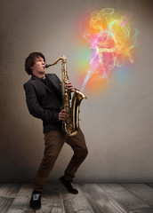Attractive musician playing on saxophone with colorful abstract