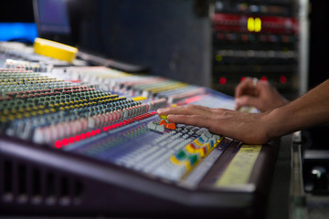 Soundman working on the mixing console.