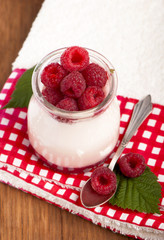 White yogurt with strawberry and spoon
