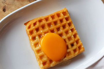 Waffle topped with eggs