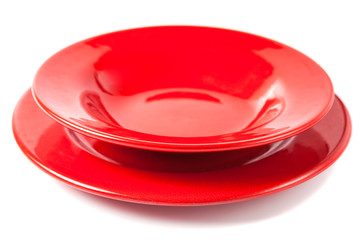 Colorful red ceramics plates on white background