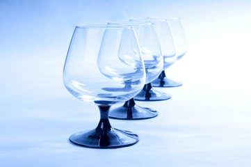 Four wineglasses on blue background