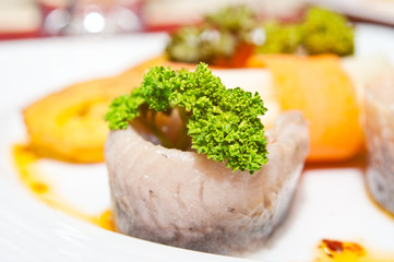 Portion of fish fillet with salad