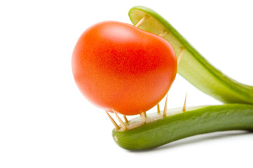 Concept.The predatory cucumber devours a tomato