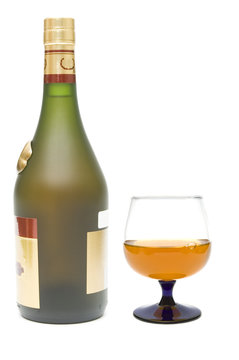 Cognac bottle and glass on white background
