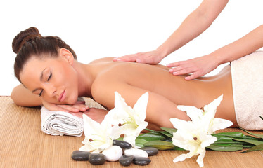 Fototapeta na wymiar Beautiful woman having relaxing massage on her back in spa salon