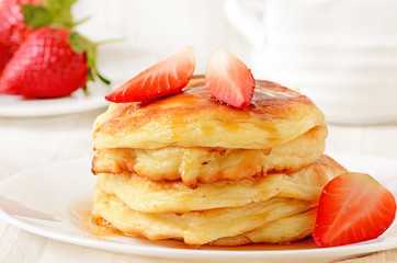 Homemade cheese pancakes and strawberries