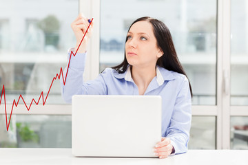 Woman drawing positive business growth
