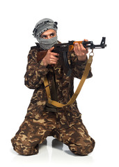 Terrorist with automatic gun on white background