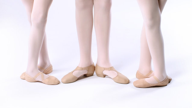 Three girls dancers feet wearing ballet shoes