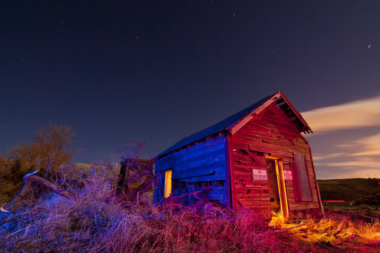Old abandoned ghost town shack lit with gelled speed lights.