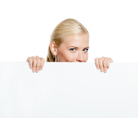 Girl looks out of the huge sheet of paper - copyspace