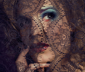 portrait of beauty young woman through lace