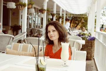 young elegant brunette woman in cafe drinking coffee