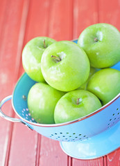 Green apples in a blue colander