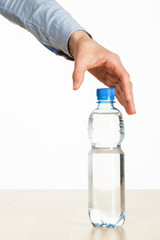 Human hand reaches out for bottle of water