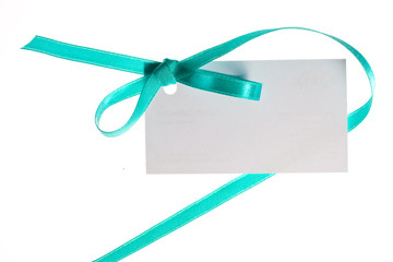 Blank gift tag tied with a satin ribbon.