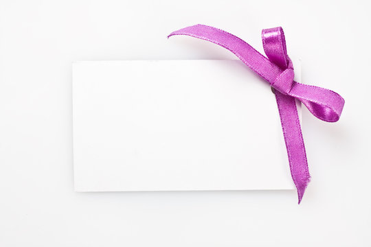 Blank gift tag tied with a satin ribbon.