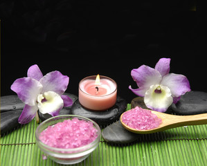 orchid with salt in bowl and candle ,grove on green mat