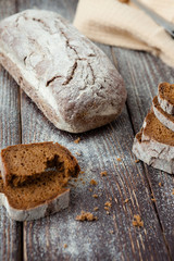 Whole-grain bread with cracks on the boards