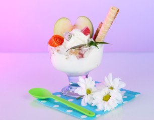 Ice cream with wafer sticks on napkin on color background