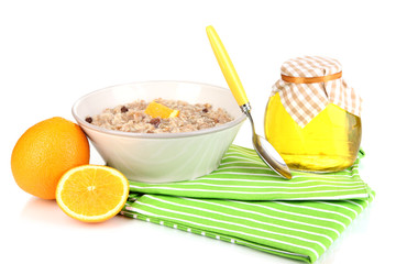 Useful oatmeal in bowl with fruit isolated on white