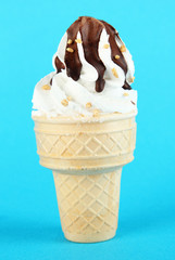Tasty ice cream with chocolate, on blue background