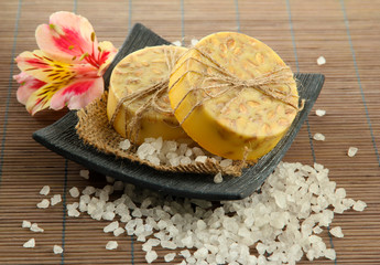 Hand-made soap and sea salt  on grey bamboo mat