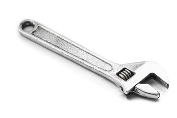 Old adjustable spanner on white background.