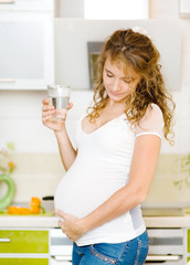 pregnant woman holding a glass of clean water